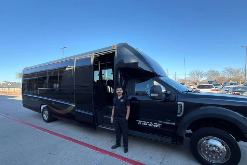 JC Limo driver standing beside luxury motor coach in Dallas providing professional group transportation service