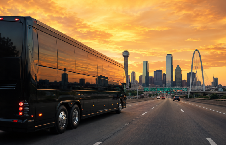 JC Limo Black tour bus driving on a highway at sunset with a city skyline and a white arch bridge in the background.